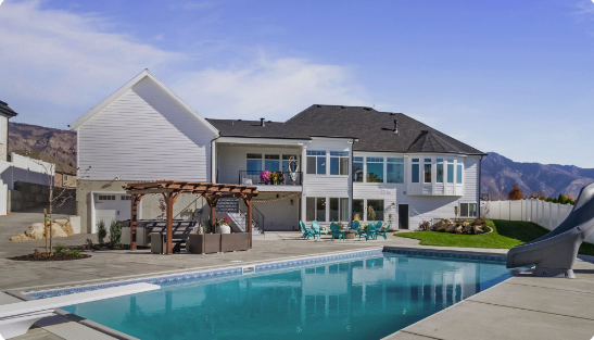 Custom backyard vinyl pool design with seating area in Farmington, Utah by Barr Pool Builders