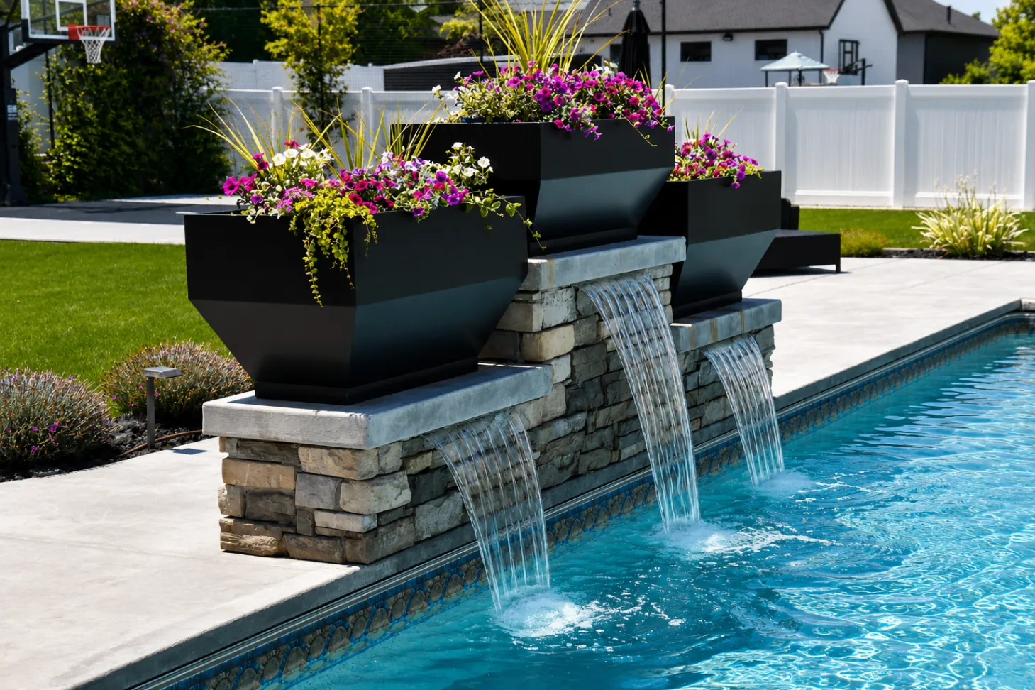 Outdoor Living Trends: Pools and Water Features in Northern Utah | Barr Pools Utah Stacked stone pool water feature with cascading sheer descents and modern planters in Northern Utah